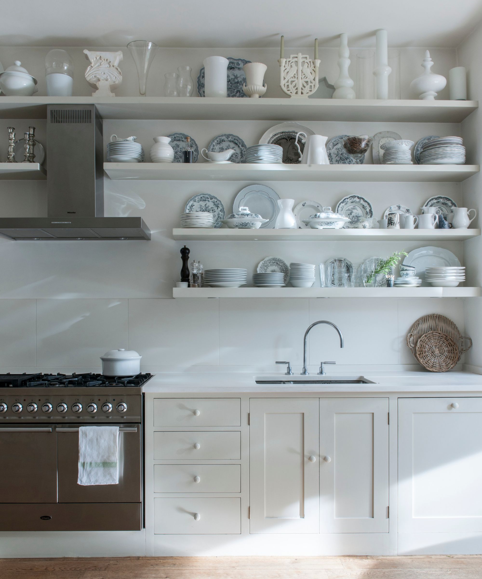 White kitchen with open shelving and range cooker