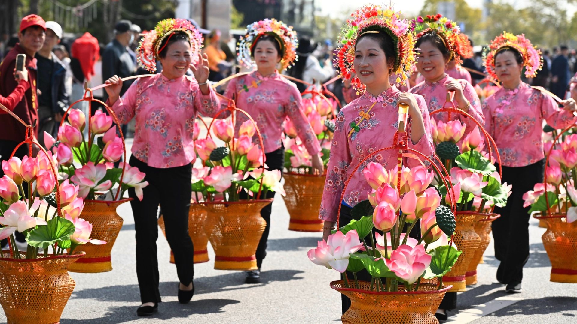 
                                Women in floral headdresses take part in the Mazu Heavenly Fragrance parade in Xunpu, China
                            