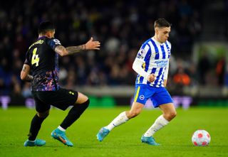 Tottenham Hotspur’s Cristian Romero (left) and Brighton and Hove Albion’s Leandro Trossard battle for the ball during the Premier League match at the AMEX Stadium, Brighton. Picture date: Wednesday March 16, 2022