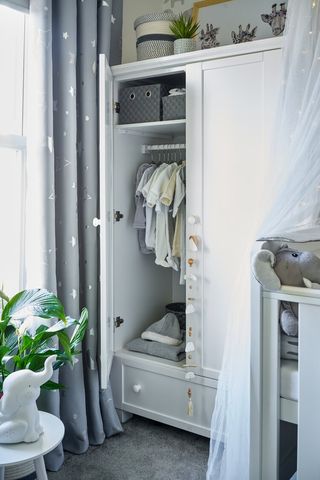 Dani Dyer nursery – wardrobe area, open with clothes inside