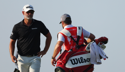 Paul Waring walks on and speaks to his caddie