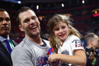 Tom Brady #12 of the New England Patriots celebrates with Vivian Lake Brady after his 13-3 win against Los Angeles Rams during Super Bowl LIII at Mercedes-Benz Stadium on February 03, 2019