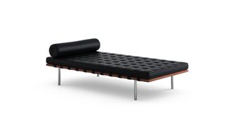 Black padded chaise longue, silver metal legs, white background