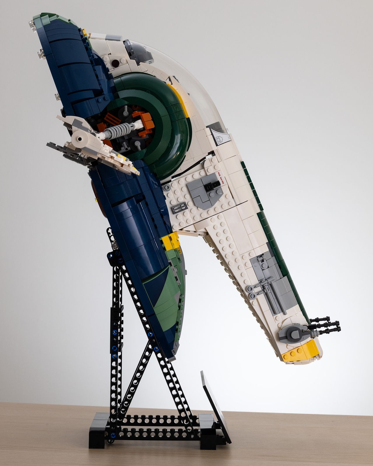 Lego Star Wars UCS Jango Fett&rsquo;s Firespray-Class Starship (75409) on a table with a white background side-on image