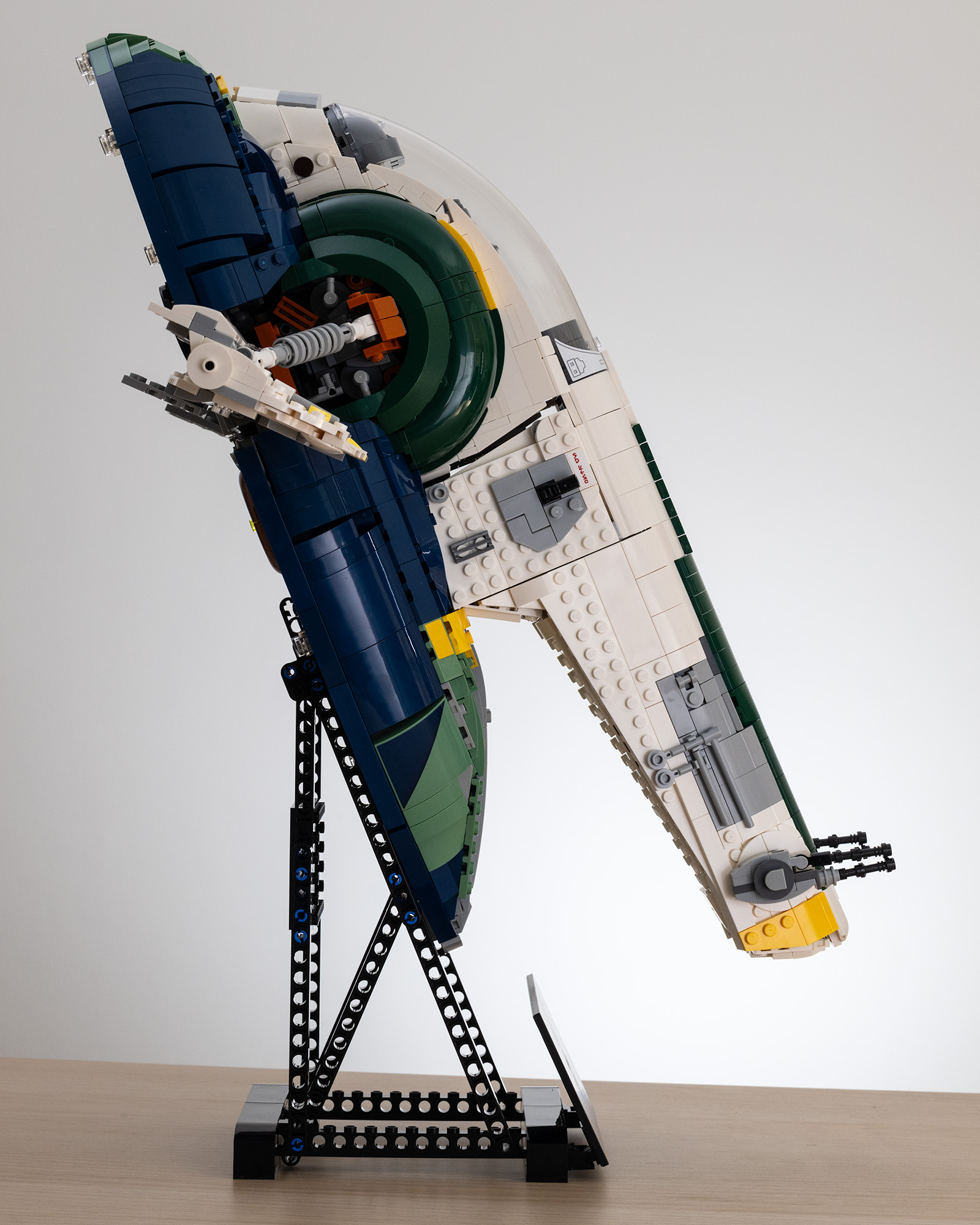 Lego Star Wars UCS Jango Fett&rsquo;s Firespray-Class Starship (75409) on a table with a white background side-on image