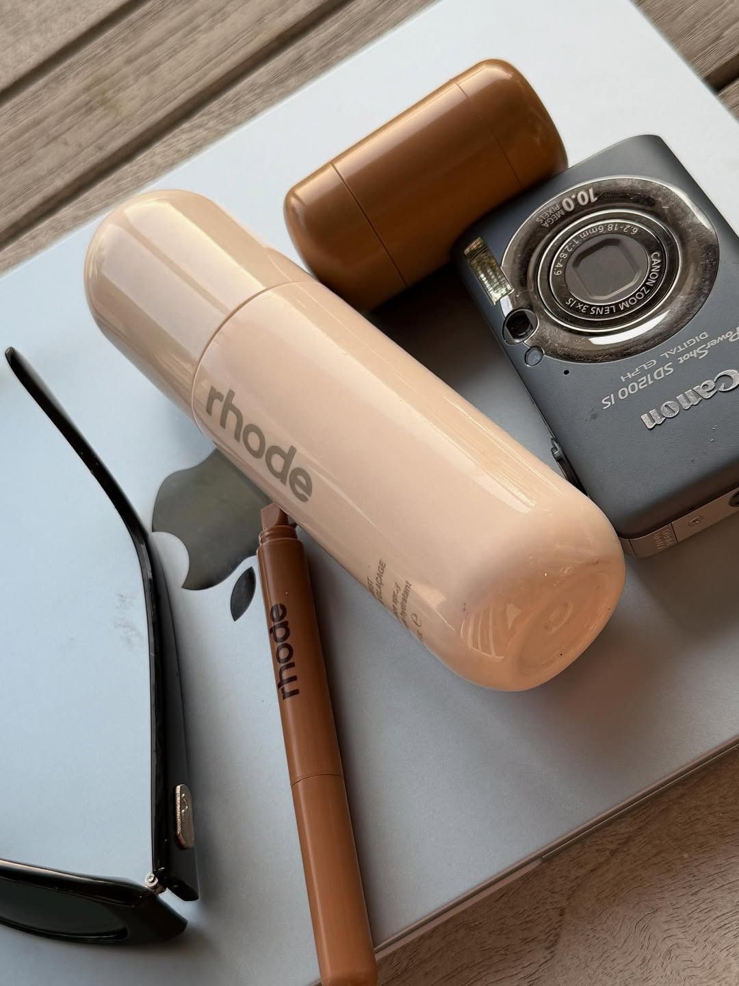 Hailey Bieber teasing the Rhode Glazing Mist in a group shot of Rhode beauty products.
