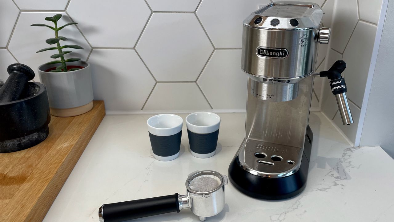 DeLonghi Dedica Style EC685 on a kitchen countertop with its accessories