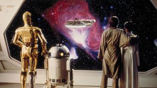 Luke, Leia, R2-D2 and C3P0 look out of a window at the Millennium Falcon in 