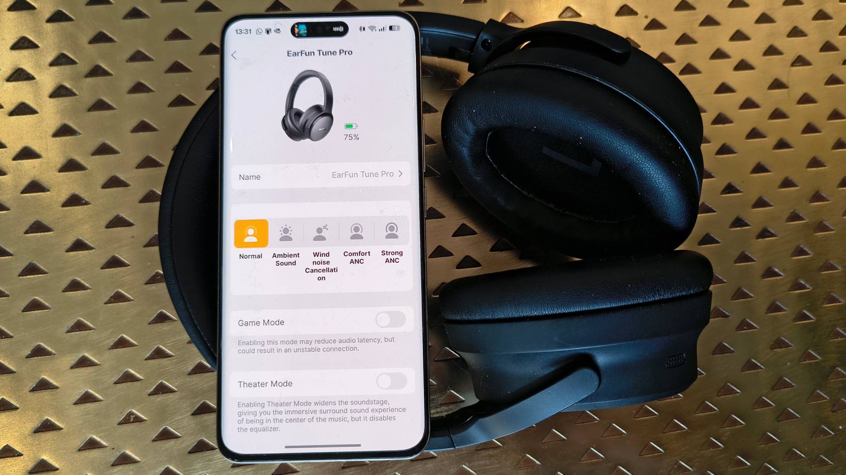 The Earfun Tune Pro atop a bronze table.