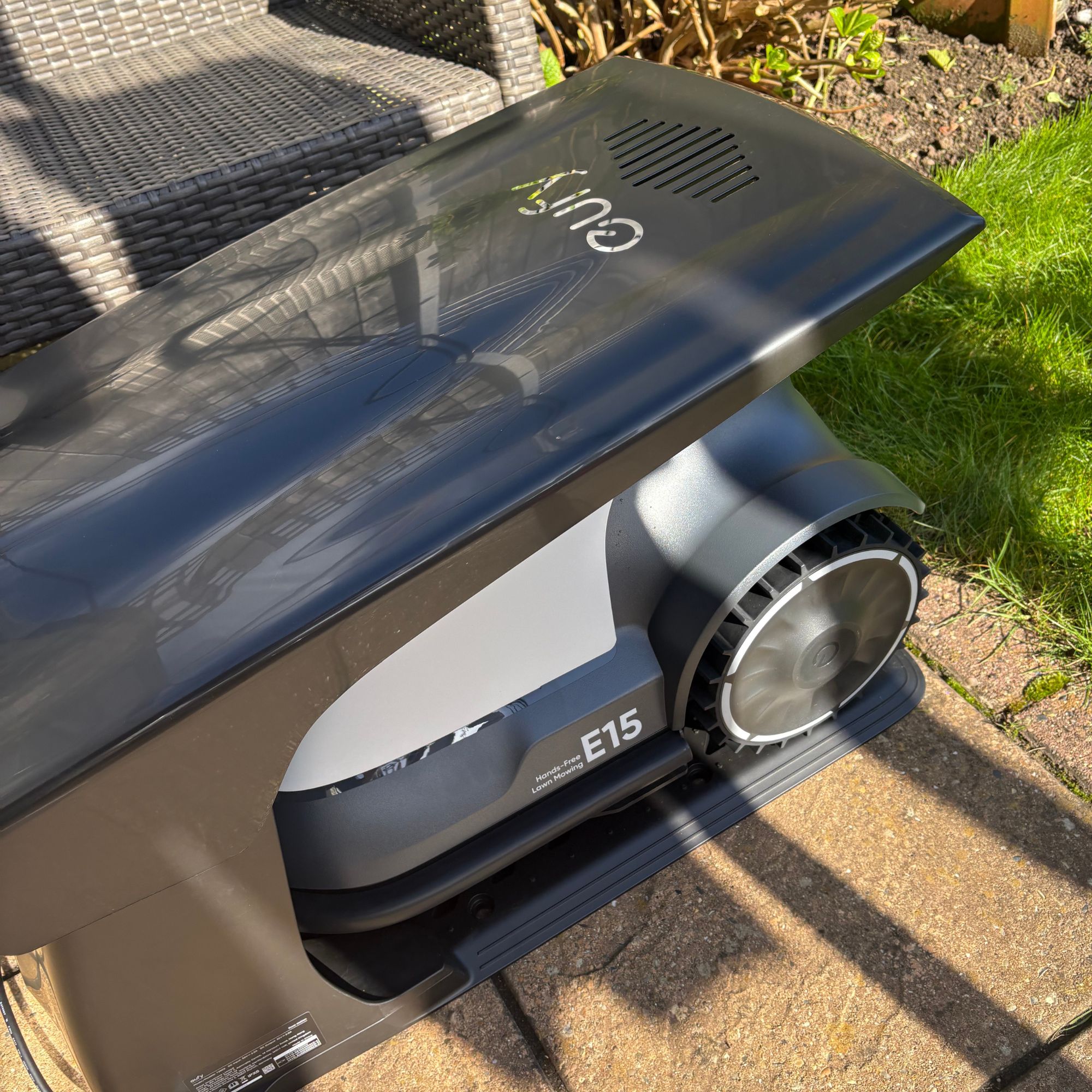 Eufy E15 Robot Lawn Mower charging in garage