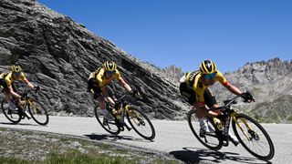 Jumbo-Visma team's Slovenian rider Primoz Roglic lead the peleton through a bend in a mountain road
