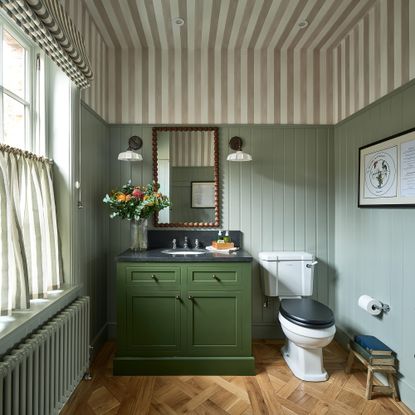 BC designs green bathroom with striped ceiling