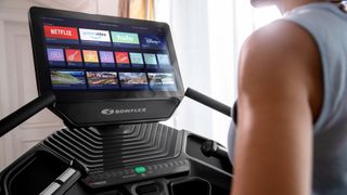 person looking at the multimedia screen of a Bowflex Treadmill 22