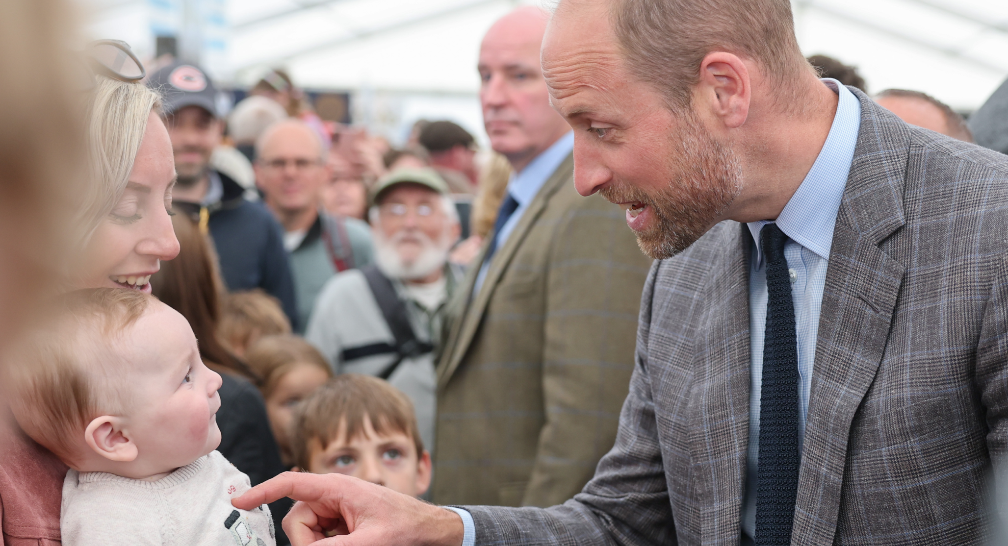 Prince William meeting a baby called George in June 2025 at the Royal Cornwall Show