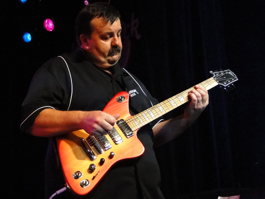 A Gibson Guitar employee demonstrates the Firebird X at New York&#039;s Hard Rock Cafe.