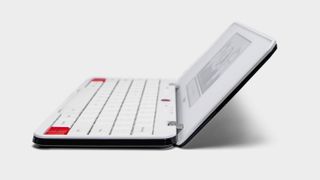 Freewrite Traveler – a low-tech laptop. A side view of a small rectangular laptop with a white keyboard.