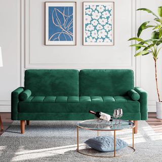 A dark green sofa in a white room