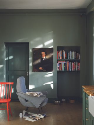 A home study space with green walls and a built-in bookshelf alcove