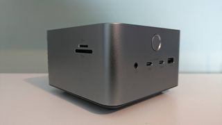 left three-quarter view of Anker Prime Docking Station (14-in-1, 8K, Thunderbolt 5) on white desk with green background