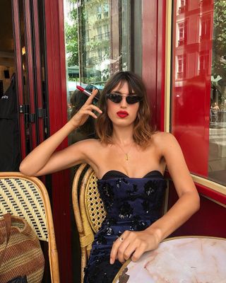 Jeanne Damas wearing red lipstick.