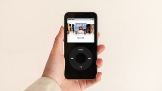 A person holding a black iPod.