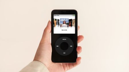 A person holding a black iPod.