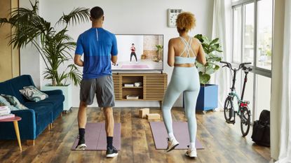 Two people exercising at home