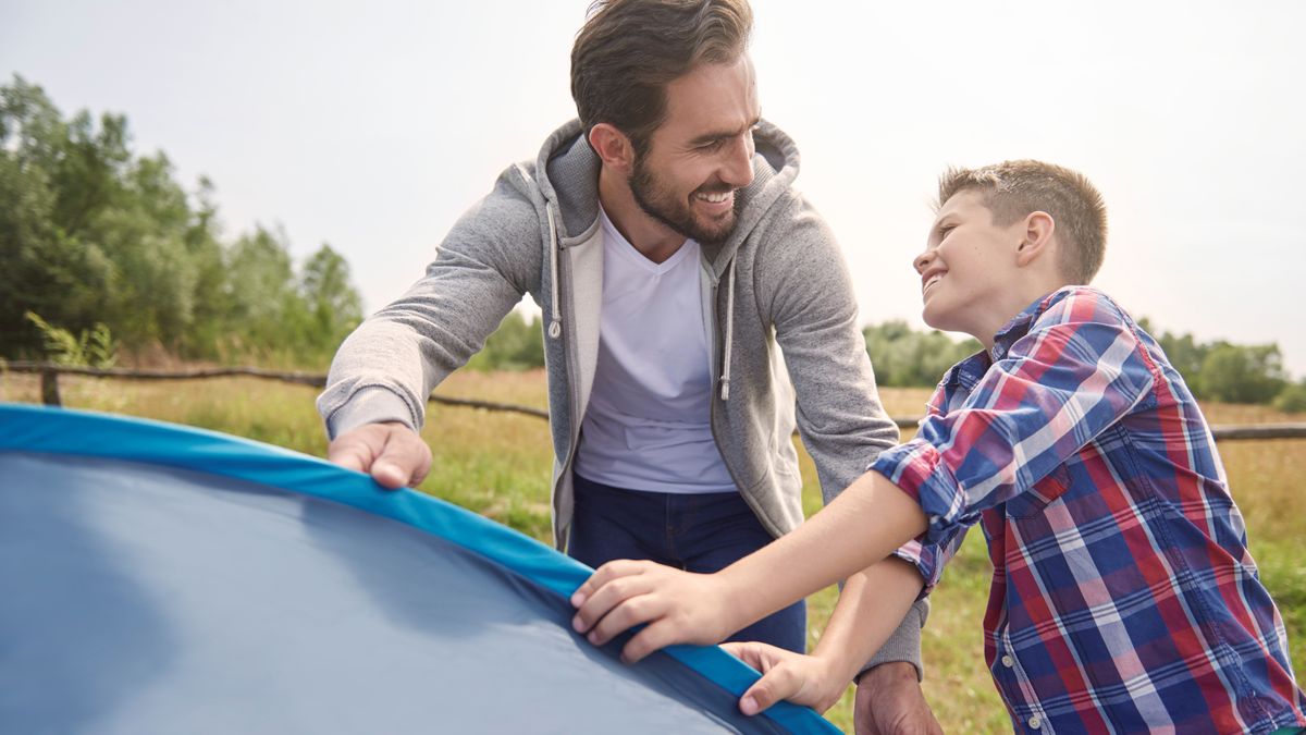 Man and his son pitching tent