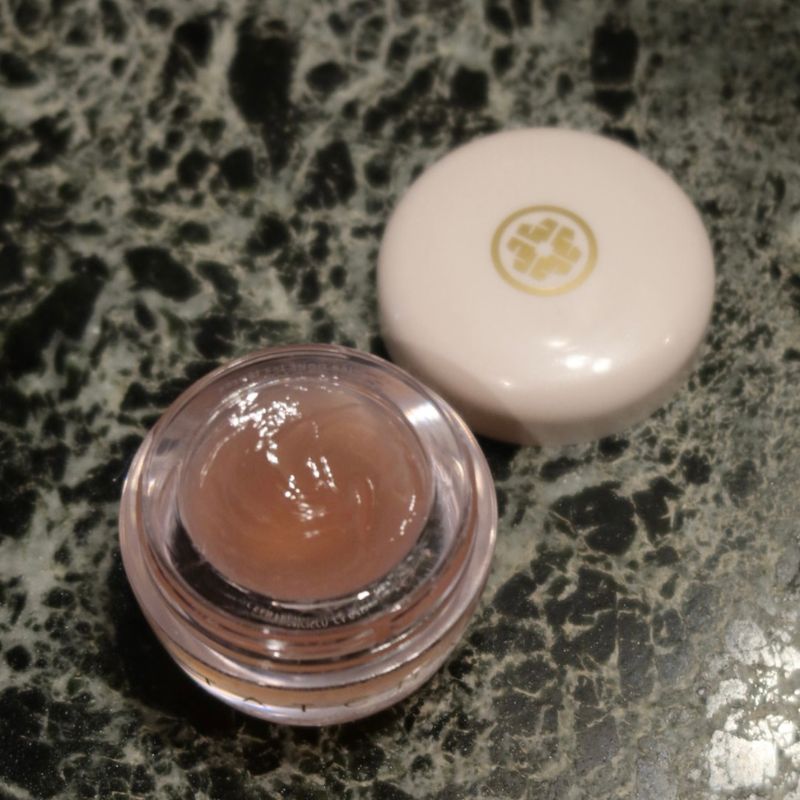 A photo of the inside of the tatcha kissu lip mask, sitting on a marble surface