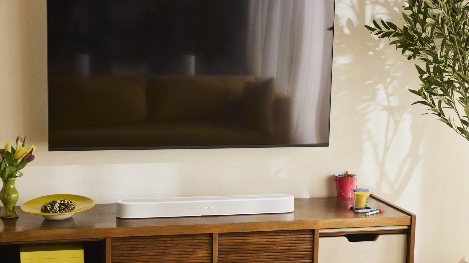 The Sonos Beam Ultra soundbar below a TV