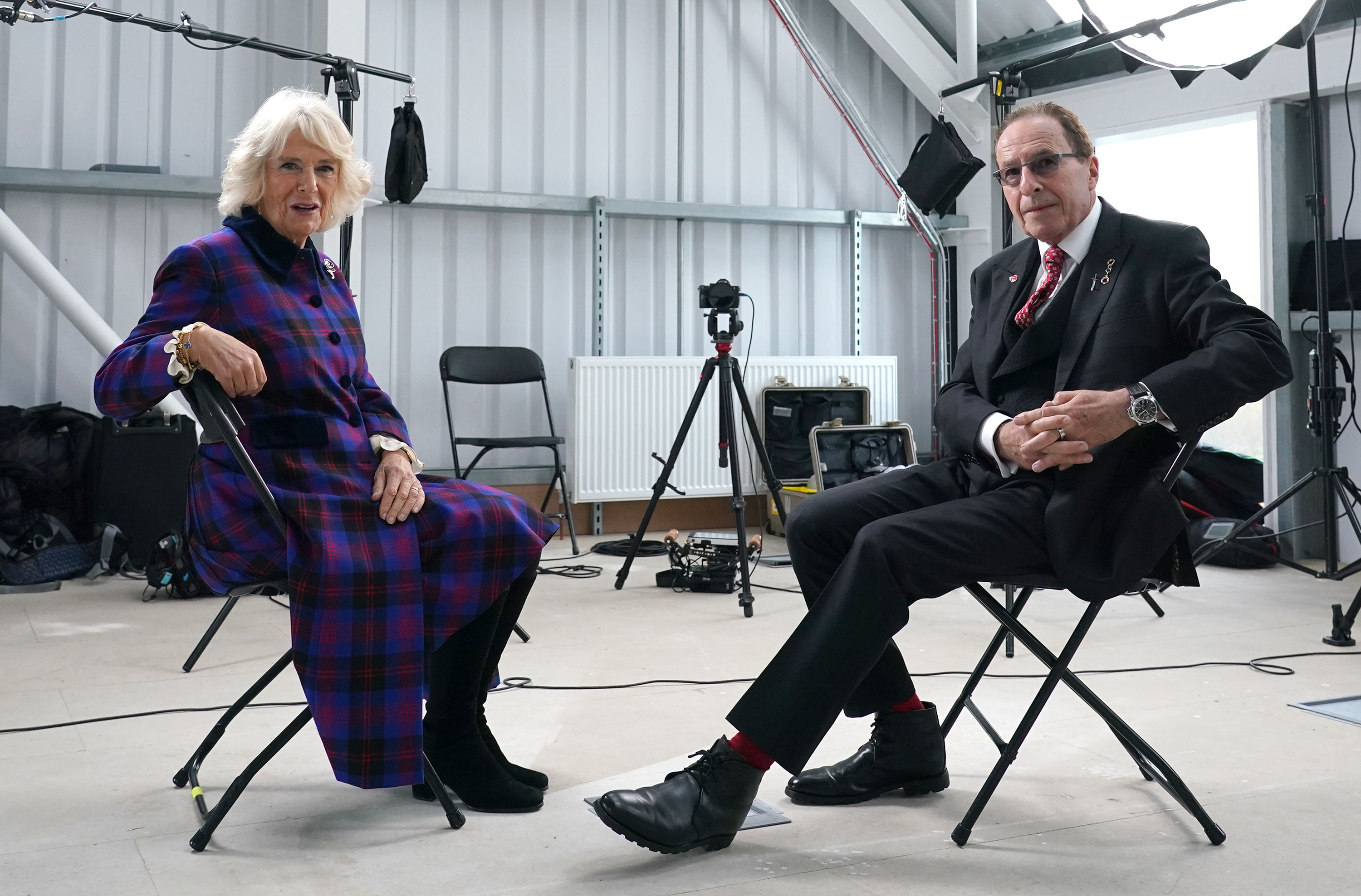 BRIGHTON, ENGLAND - NOVEMBER 04: Camilla, Duchess of Cornwall speaks with author Peter James during her visit to the set of ITV's Adaptation Of The Roy Grace Series By Peter James on November 4, 2021 in Brighton, England. (Photo by Gareth Fuller - WPA Pool/Getty Images)