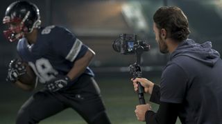 DJI RS 4 gimbal on set in the hand filming action