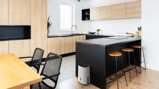 dehumidifier in modern kitchen with black island