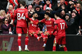 Liverpool's Colombian midfielder #07 Luis Diaz (2nd R) celebrates with Liverpool's English midfielder #17 Curtis Jones (R), Liverpool's Egyptian striker #11 Mohamed Salah and Liverpool's Northern Irish defender #84 Conor Bradley after scoring his team first goal during the English Premier League football match between Liverpool and West Ham United at Anfield in Liverpool, north west England on April 13, 2025.