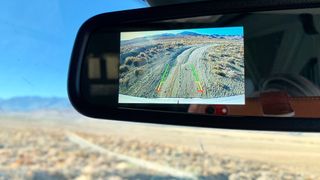 Landscape reflected in rear-view mirror