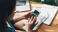 Close up of woman using phone calculator