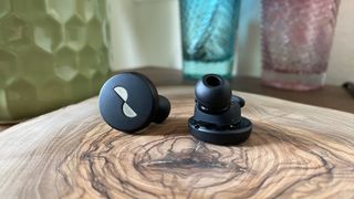 NuraTrue workout earbuds on a table