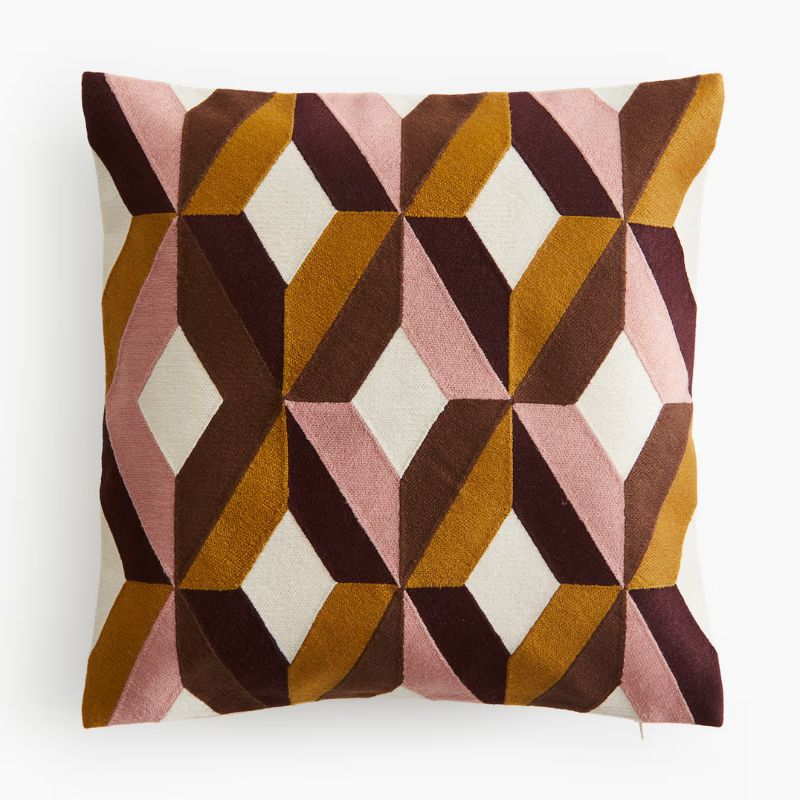 brown and pink geometric pattern cushion