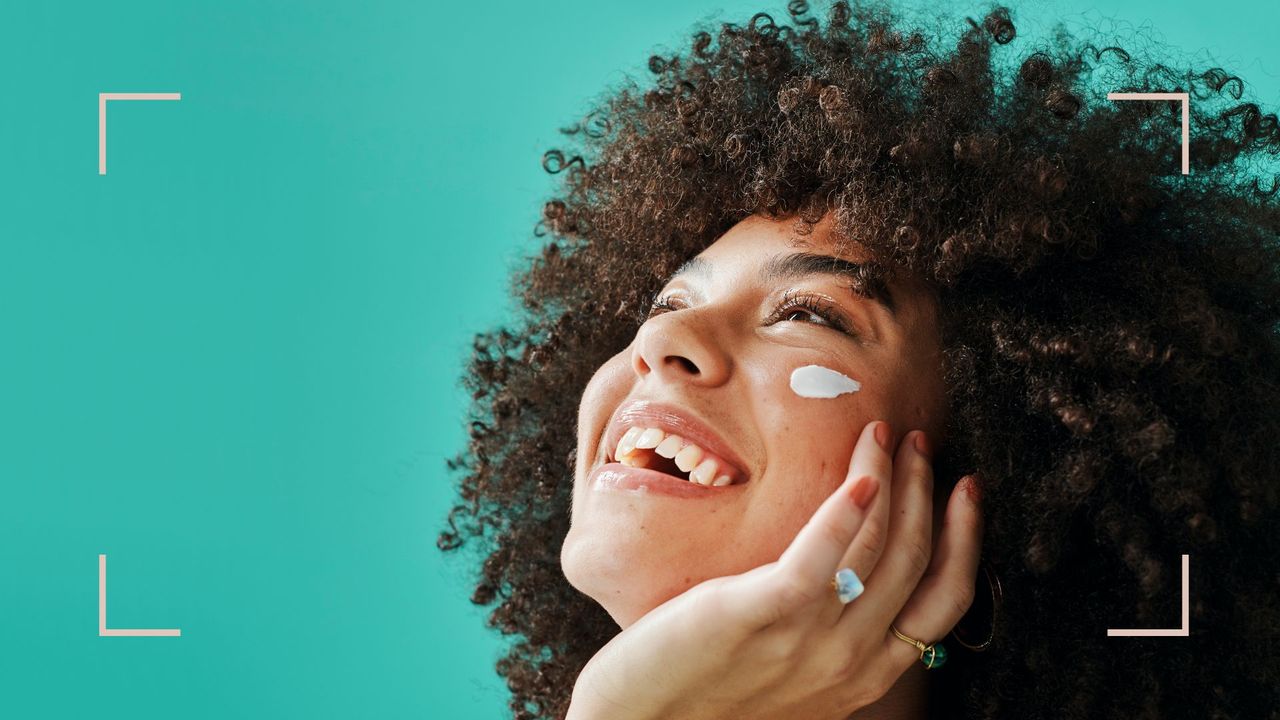 A woman showing how to fix dry skin by applying moisturizer on her face