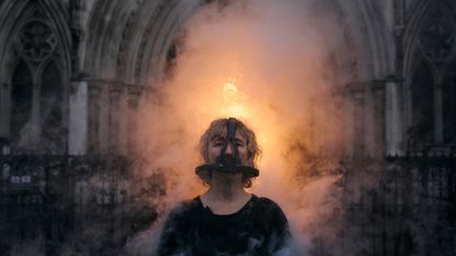 An activist from Ocean Rebellion stands as she wears a Scold's Bridlesmedieval torture device, during an action outside the Royal High Court of Justice.