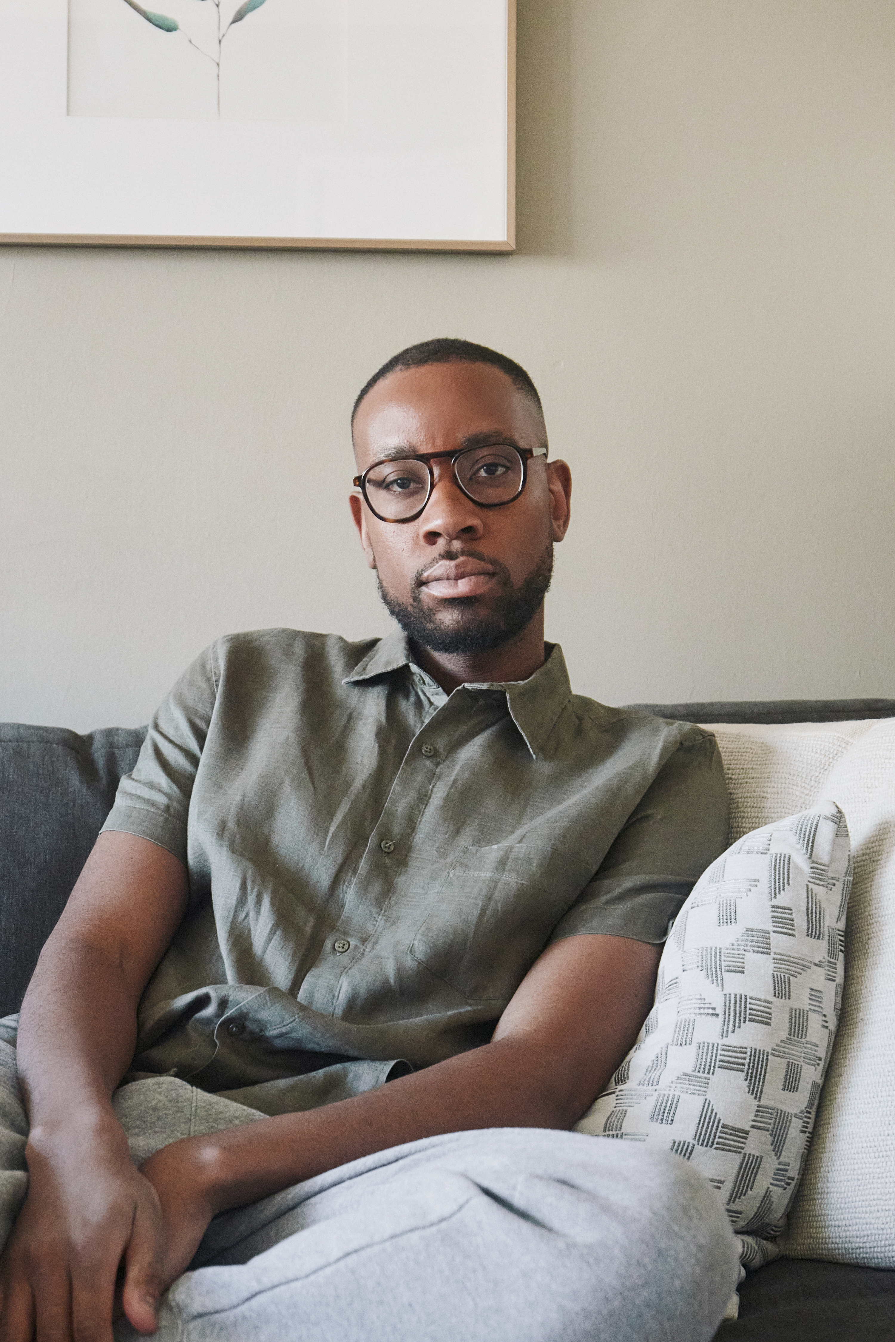 Headshot of kudzi Chikumbu sitting on a couch