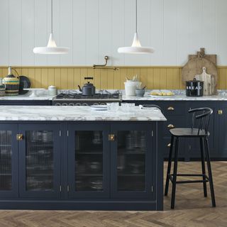 kitchen with blue island and yellow splash back