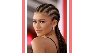 Zendaya with cornrows and wearing a black and silver lace dress as she attends Sony Pictures' "Spider-Man: No Way Home" Los Angeles Premiere on December 13, 2021 in Los Angeles, California.