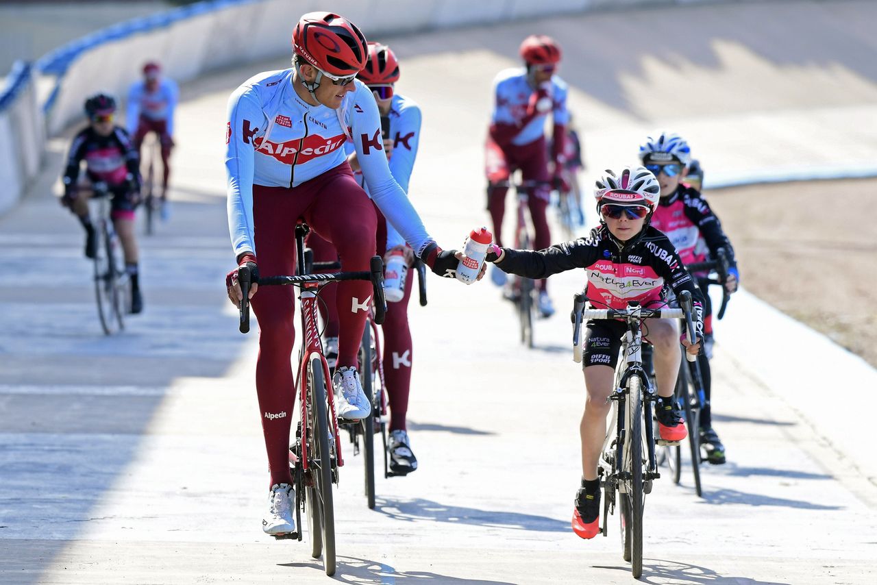 Nils Politt (Katusha-Alpecin) gives a bottle hand-up to a young fan