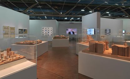 The major new exhibition on the work of Frank Gehry at the Centre Pompidou. A gallery with glass cases containing wooden architectural structures.