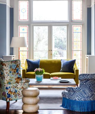 Yellow sofa, flower design armchair, blue walls