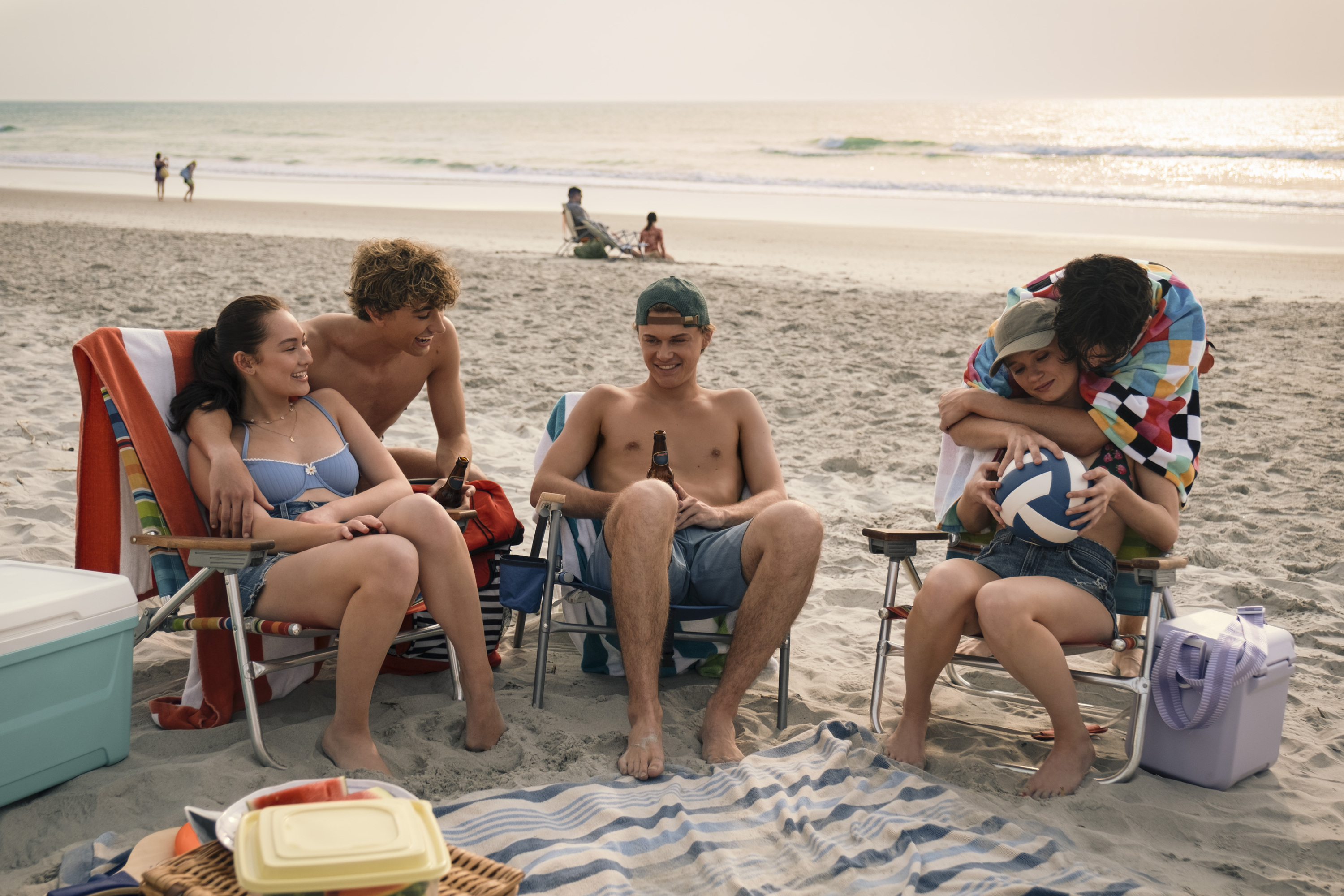 belly jeremiah conrad taylor and steven sit together on the beach in the summer i turned pretty season 3