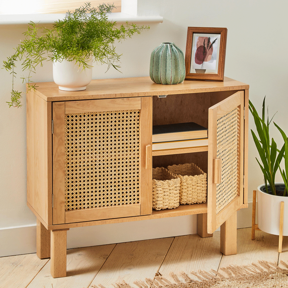 Rattan sideboard with pot plant on top