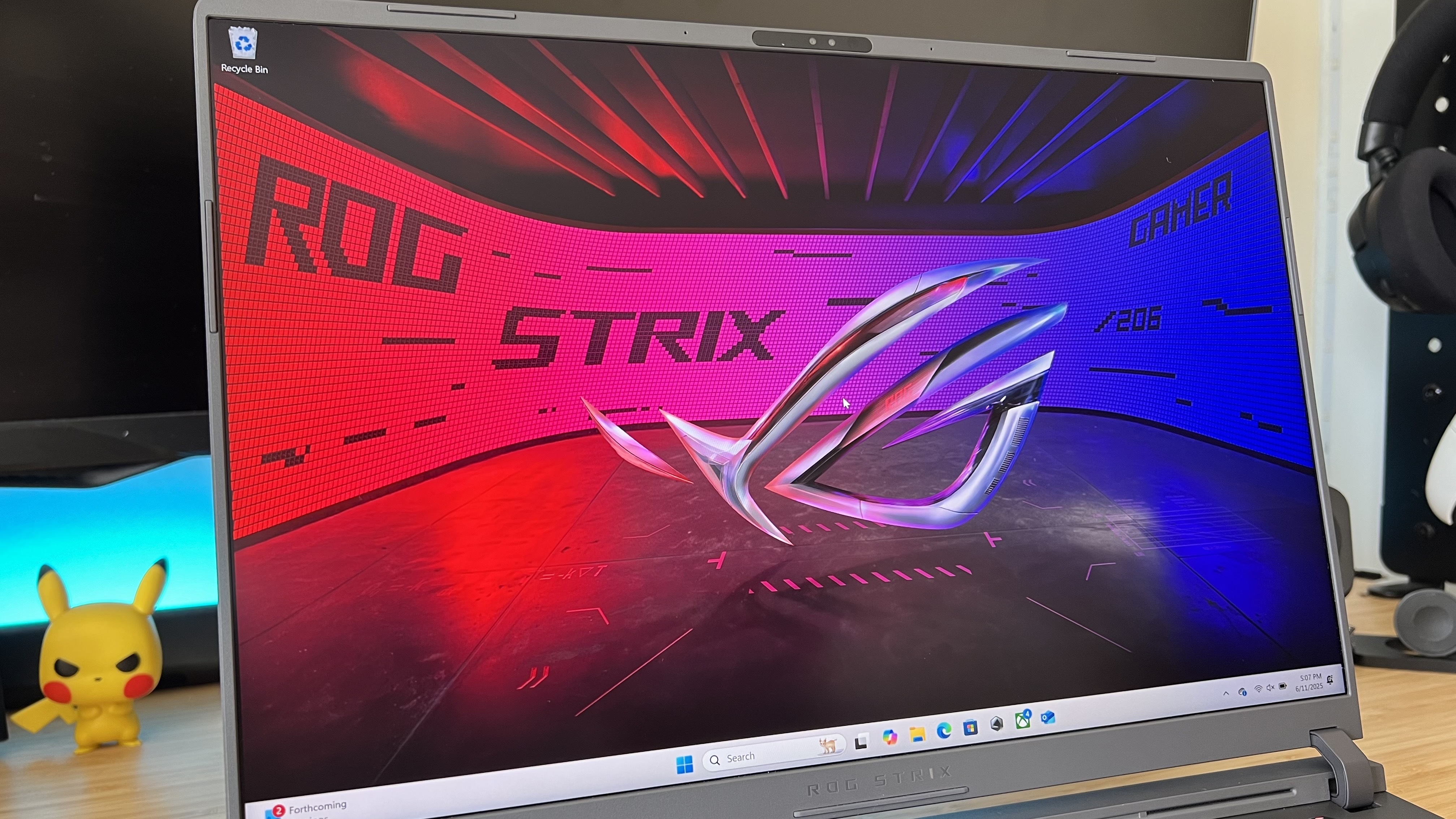 Close up on display of Asus ROG Strix G16 gaming laptop, with screen showing main desktop