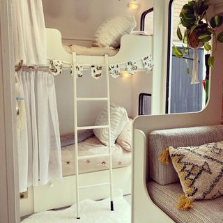 caravan interior with white bunk beds